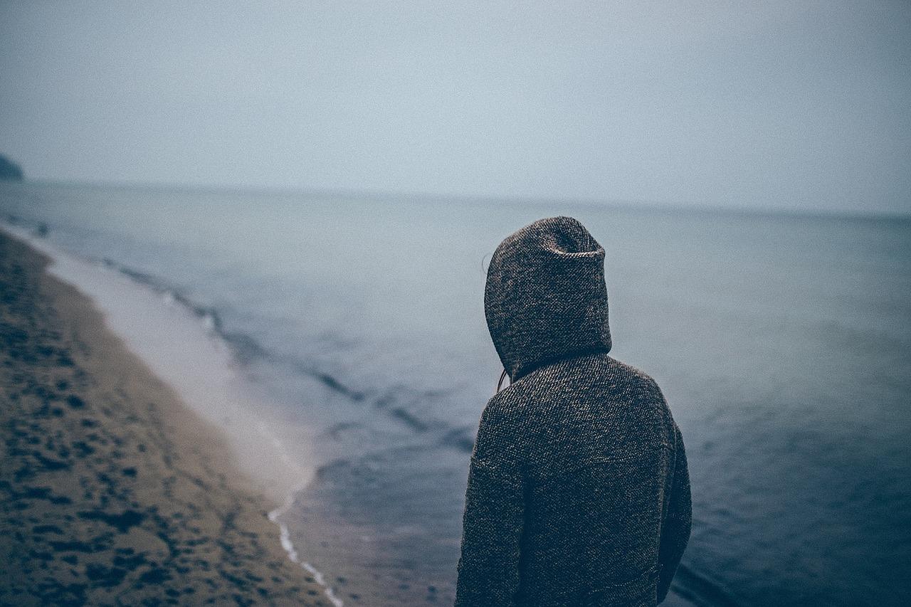 Photo of a bored guy on the beach