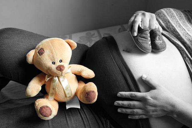Pregnant girl with a teddy bear