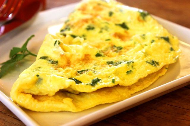 Photo of delicious omelet with herbs
